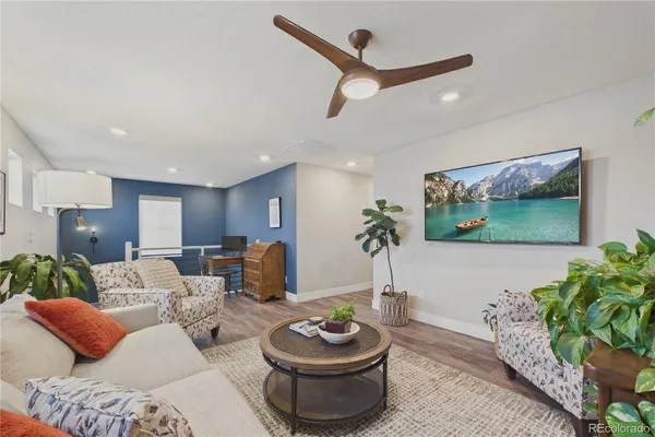 a living room with furniture and a potted plant
