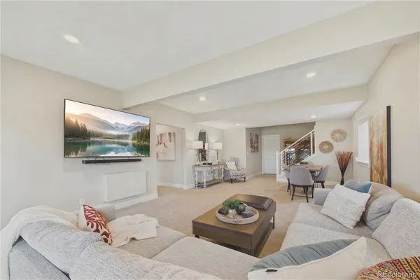 a living room with furniture a rug and a flat screen tv