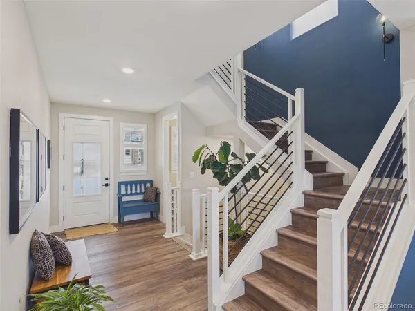 a view of entryway and hall with wooden floor