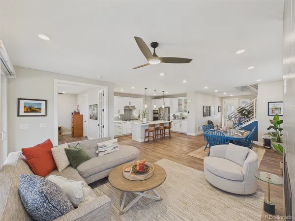 a living room with furniture a rug and white walls