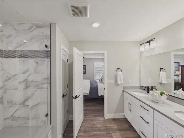 a spacious bathroom with double vanity and mirrors