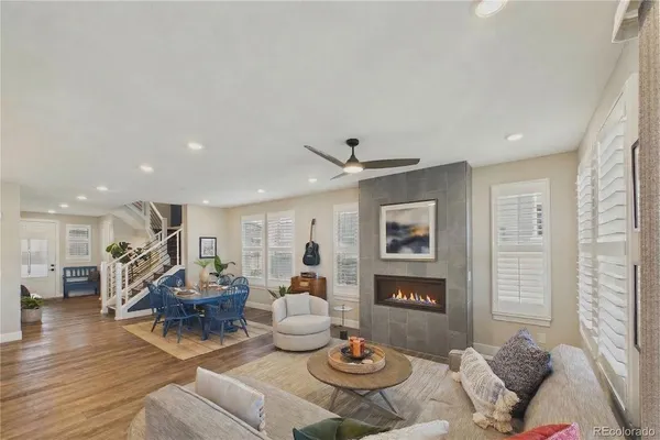 a living room with furniture kitchen view and a window