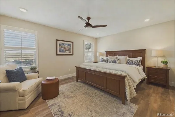 a spacious bedroom with a bed and a couch