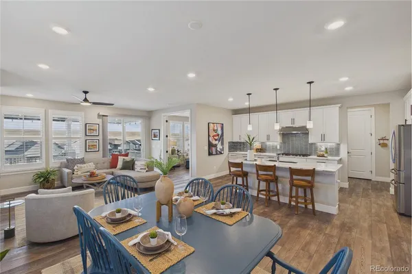 a living room with lots of furniture and kitchen view