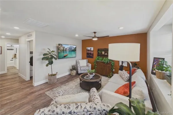 a living room with furniture and a potted plant