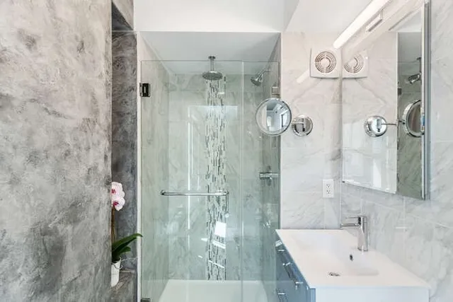 a bathroom with a shower and sink