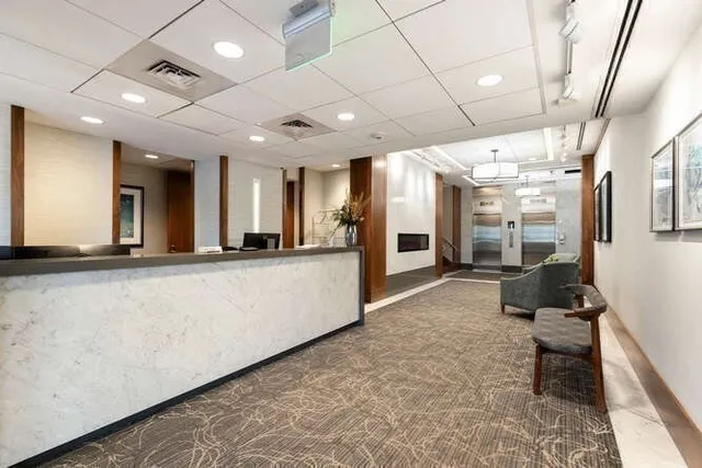 a lobby with furniture and a rug