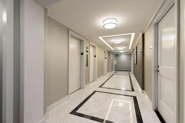 a view of a hallway with a large window and a hallway