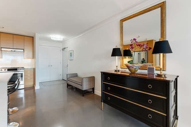 8 Whittier Place, Unit 21E Boston, MA 02114 - Photo 4 of 34 a room with a bed and a mirror