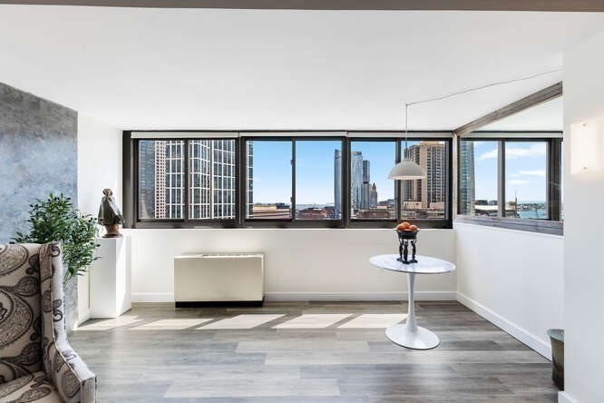 8 Whittier Place, Unit 21E Boston, MA 02114 - Photo 10 of 34 a living room with furniture and a large window