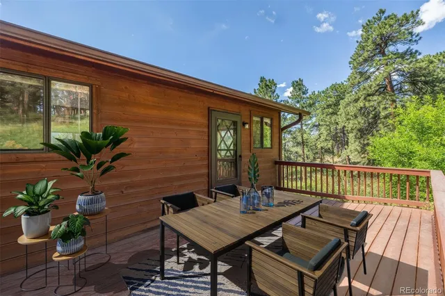 a backyard of a house with plants and wooden fence