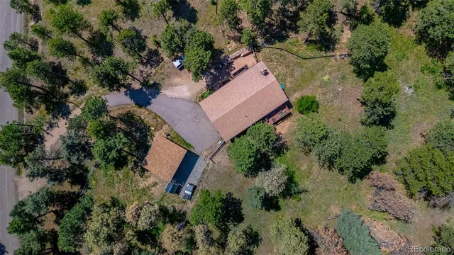 an aerial view of a house with a yard