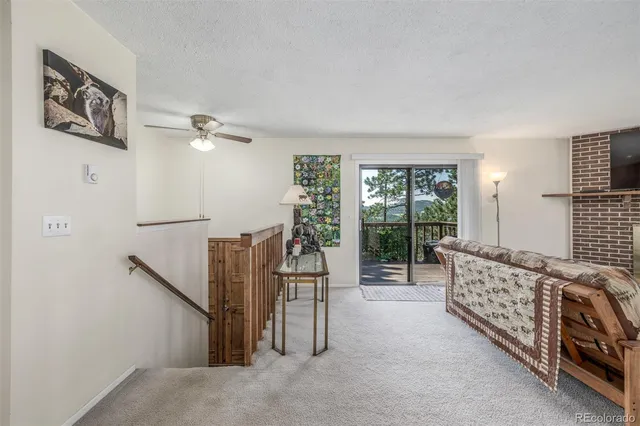 a living room with furniture flat screen tv and a large window