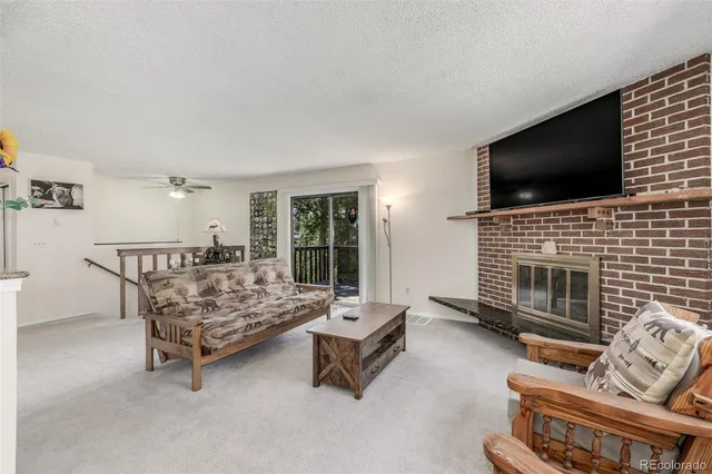a living room with furniture flat screen tv and a fireplace