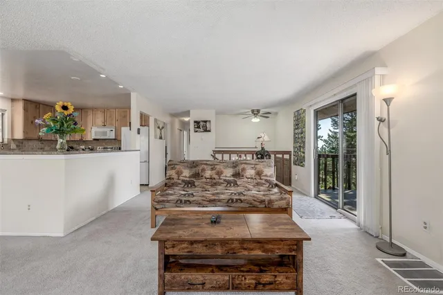 a view of a kitchen with kitchen island a counter top space a stove and cabinets