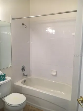 a bathroom with a bathtub and a toilet