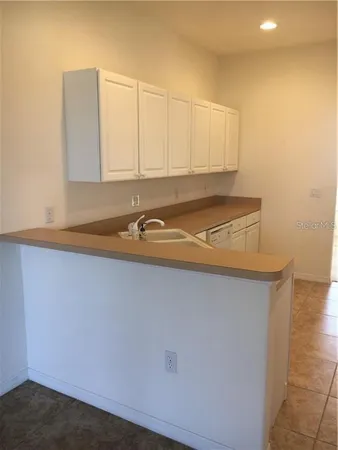 a kitchen with a sink and cabinets