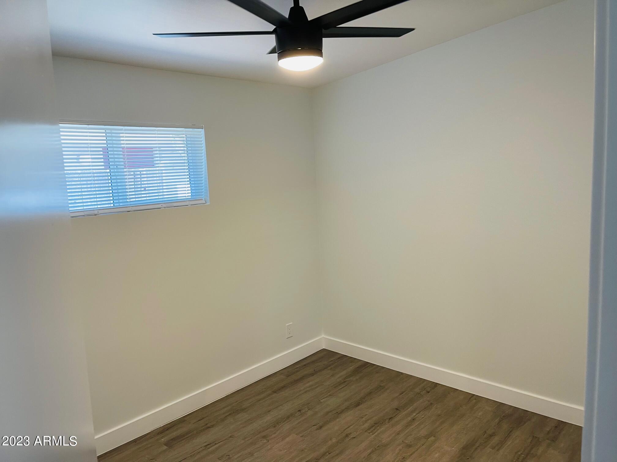 6233 North 13th Place, Unit 1 Phoenix, AZ 85014 - Photo 13 of 20 a view of a room with wooden floor and a ceiling fan