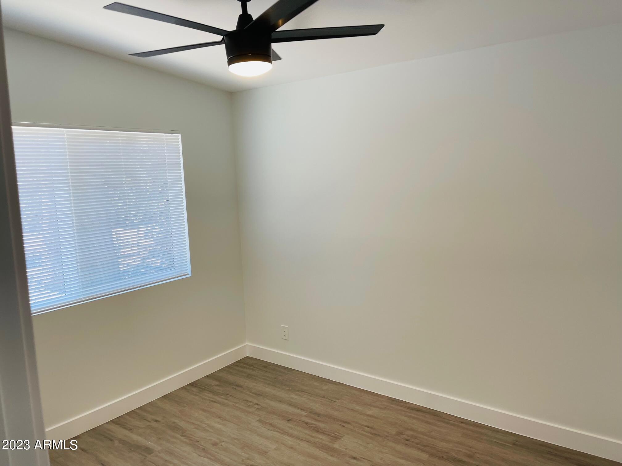 6233 North 13th Place, Unit 1 Phoenix, AZ 85014 - Photo 14 of 20 a view of a small space with wooden floor and a window