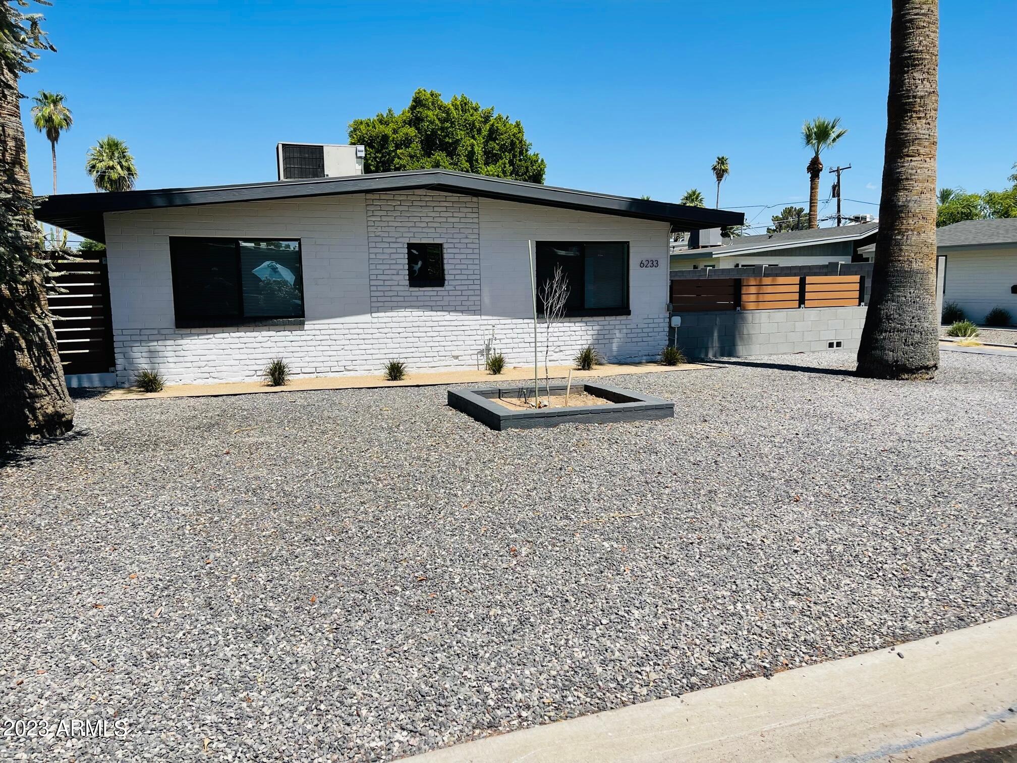 6233 North 13th Place, Unit 1 Phoenix, AZ 85014 - Photo 2 of 20 a front view of a house with cars parked