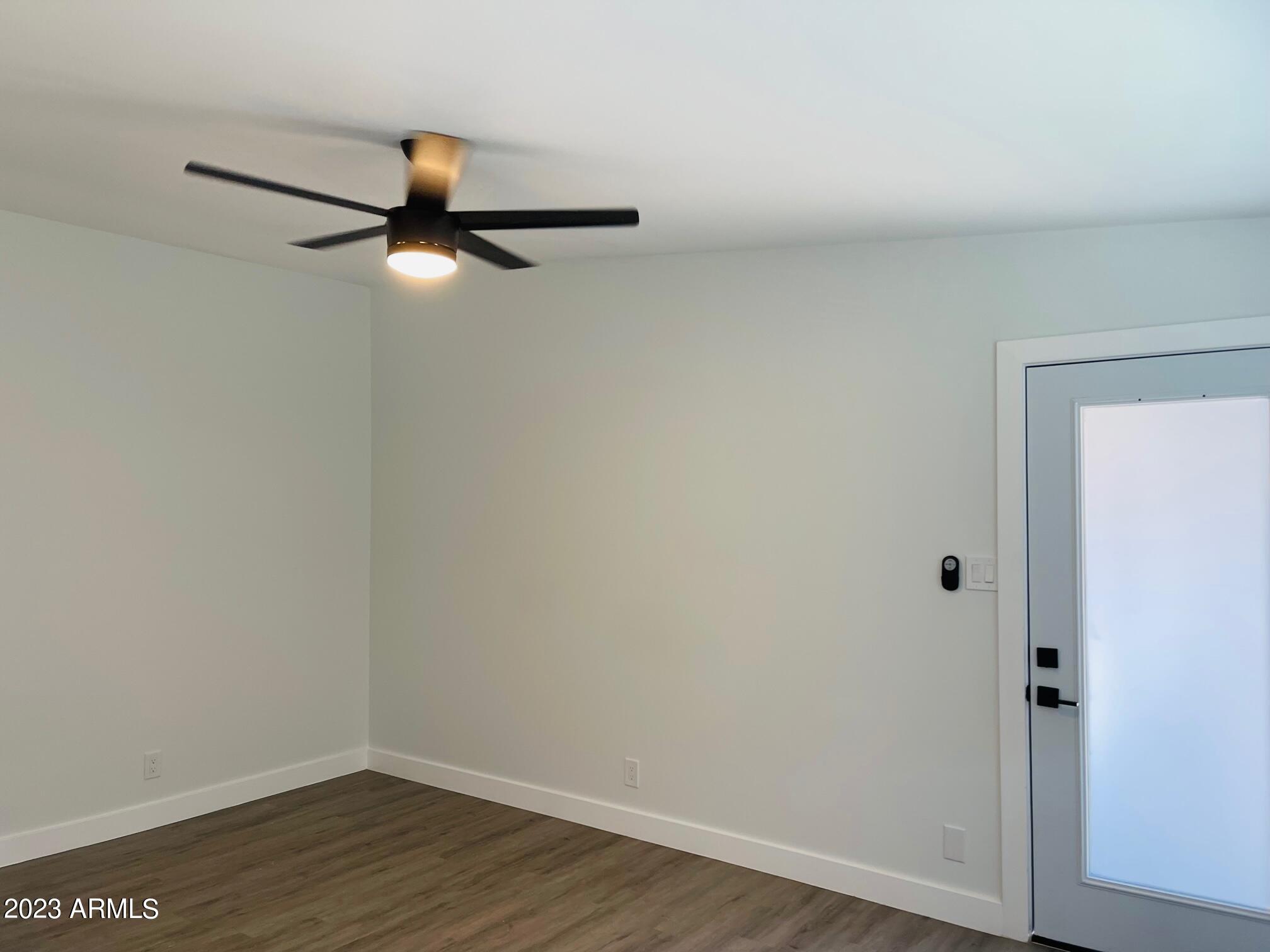 6233 North 13th Place, Unit 1 Phoenix, AZ 85014 - Photo 7 of 20 a view of a room with wooden floor and cabinet