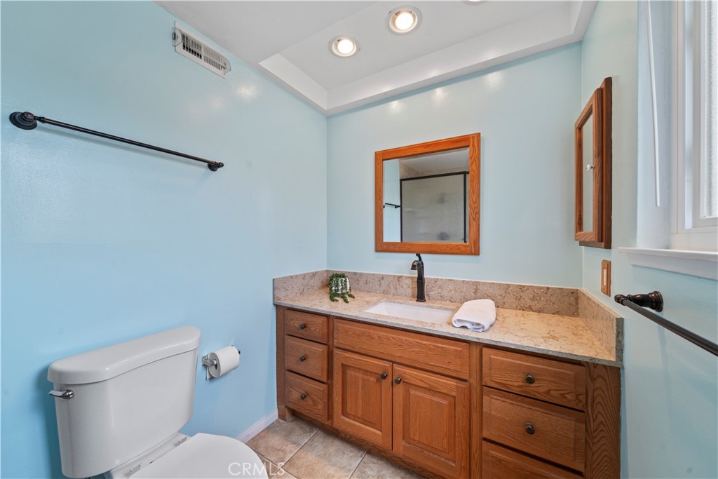 5161 Rotherham Circle Westminster, CA 92683 - Photo 11 of 24 a bathroom with a toilet sink and mirror