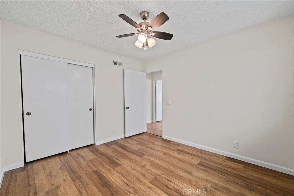 5161 Rotherham Circle Westminster, CA 92683 - Photo 13 of 24 an empty room with wooden floor and ceiling fan