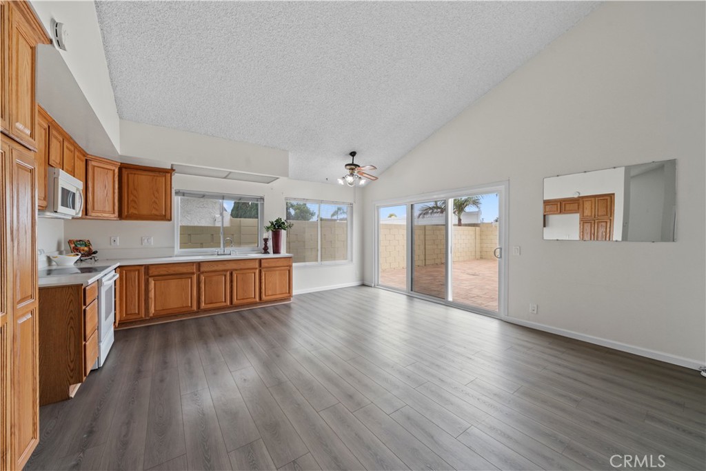 5161 Rotherham Circle Westminster, CA 92683 - Photo 4 of 24 a large white kitchen with wooden floors and stainless steel appliances