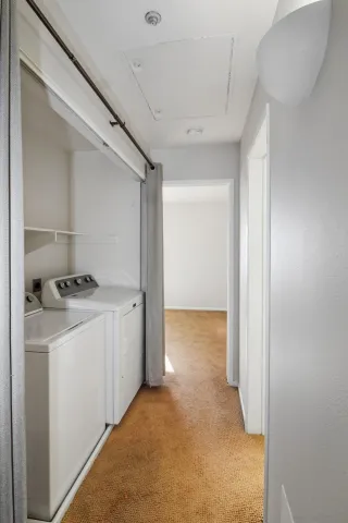 a view of storage and utility room with washer and dryer