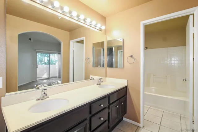 a bathroom with a sink double vanity and a mirror