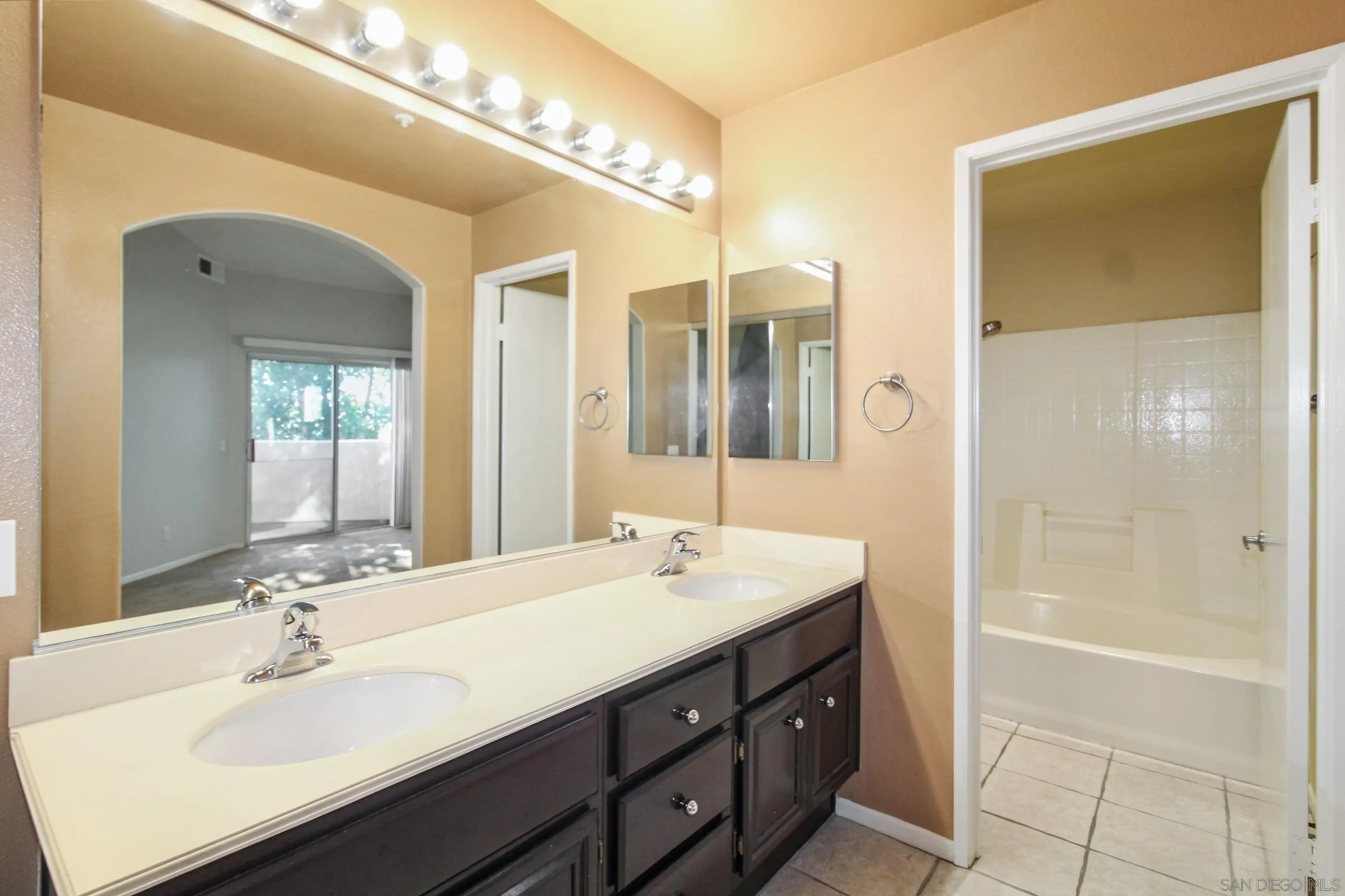 11175 Affinity Court, Unit 45 San Diego, CA 92131 - Photo 25 of 36 a bathroom with a sink double vanity and a mirror