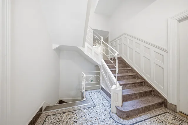 a view of a entryway with wooden floor and a rug