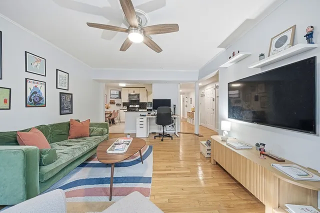 a living room with furniture a flat screen tv and a table