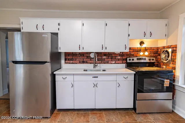 a kitchen with cabinets and white appliances