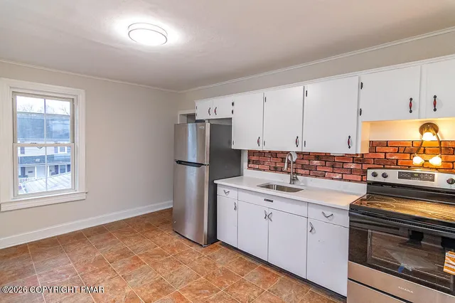 a kitchen with a sink stove and refrigerator