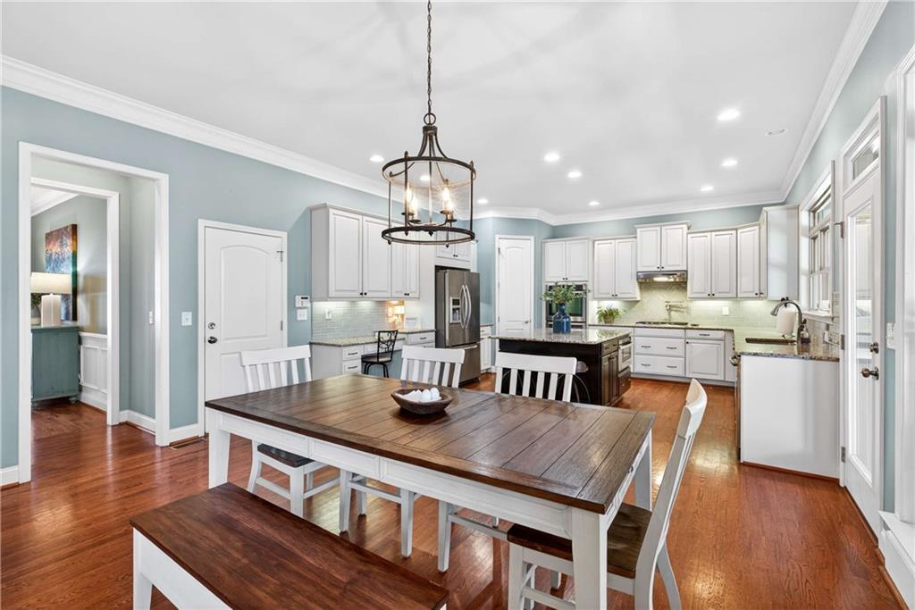 340 Scott Farm Drive Powder Springs, GA 30127 - Photo 13 of 59 a kitchen with stainless steel appliances granite countertop a kitchen island a stove a table and chairs
