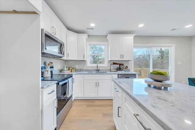 a kitchen with stainless steel appliances granite countertop sink stove and granite counter top