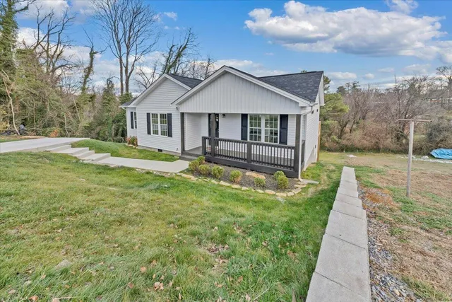 a front view of house with yard and green space