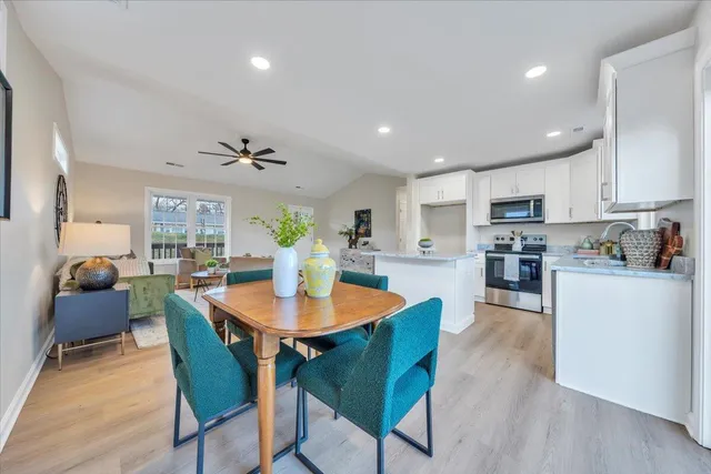 a view of a dining room with furniture and wooden floor