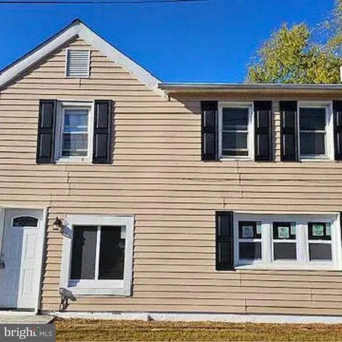a view of a house with more windows and brick walls