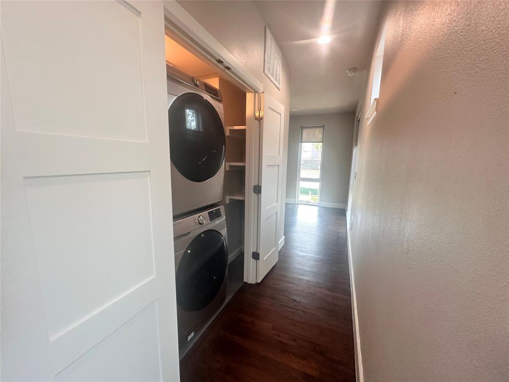 2016 North Fitzhugh Avenue, Unit 101 Dallas, TX 75204 - Photo 12 of 26 Laundry room with built-in shelving, textured wall, and room for a stackable washer and dryer
