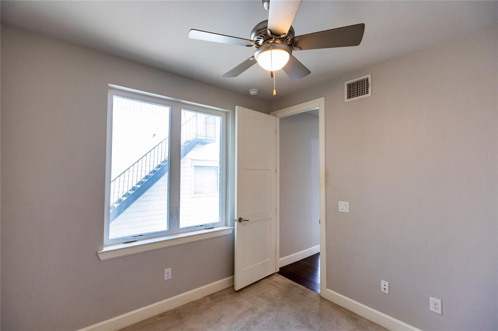 2016 North Fitzhugh Avenue, Unit 101 Dallas, TX 75204 - Photo 19 of 26 Secondary bedroom featuring light colored carpet and ceiling fan