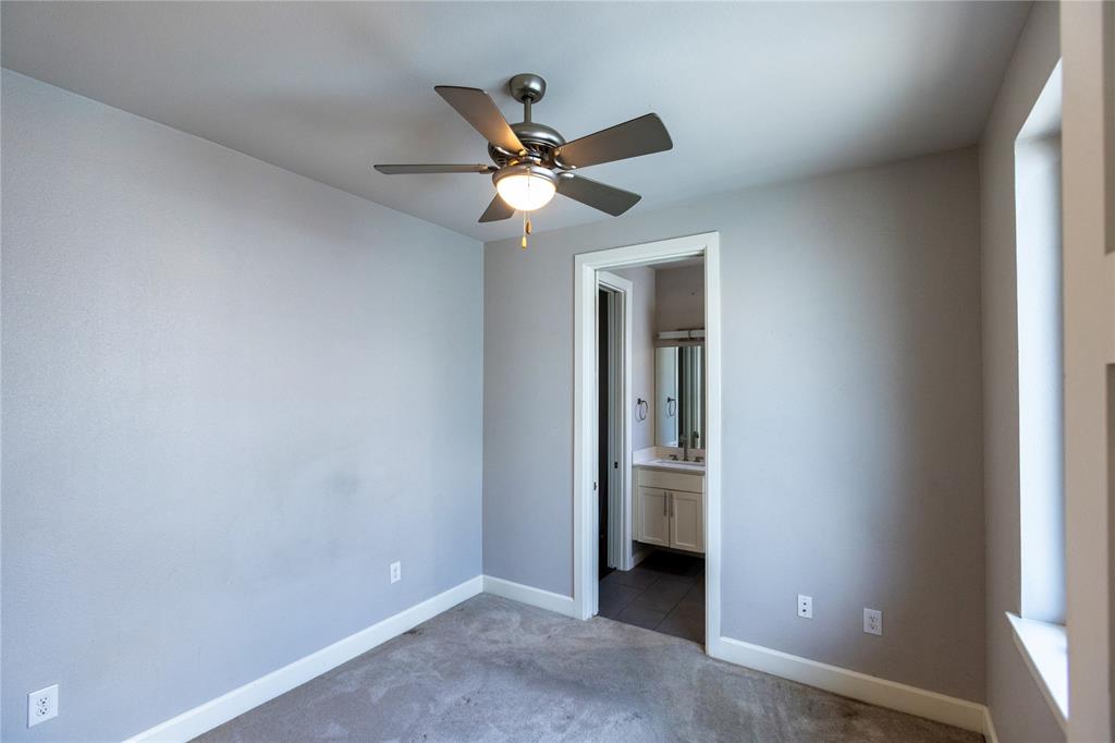 2016 North Fitzhugh Avenue, Unit 101 Dallas, TX 75204 - Photo 21 of 26 Secondary bedroom featuring carpet floors, ensuite bath, and ceiling fan