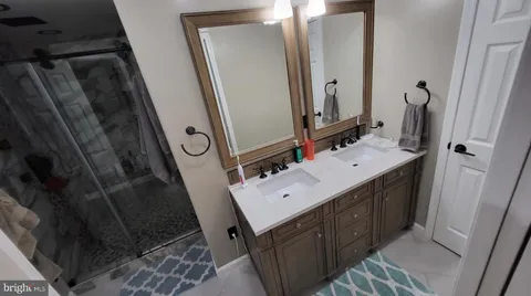 a bathroom with a sink vanity mirror and toilet