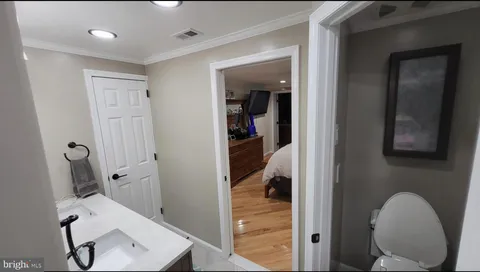 a view of a hallway with workspace and a couch