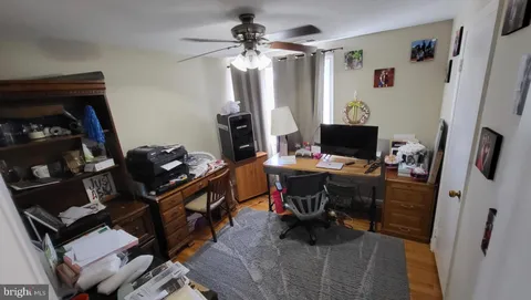 a view of a workspace with furniture and a window