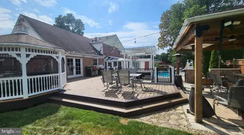 a view of a house with backyard porch and sitting area