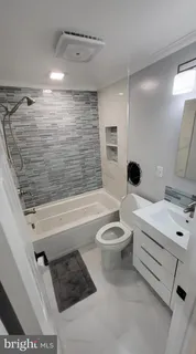 a bathroom with a toilet a sink and bathtub