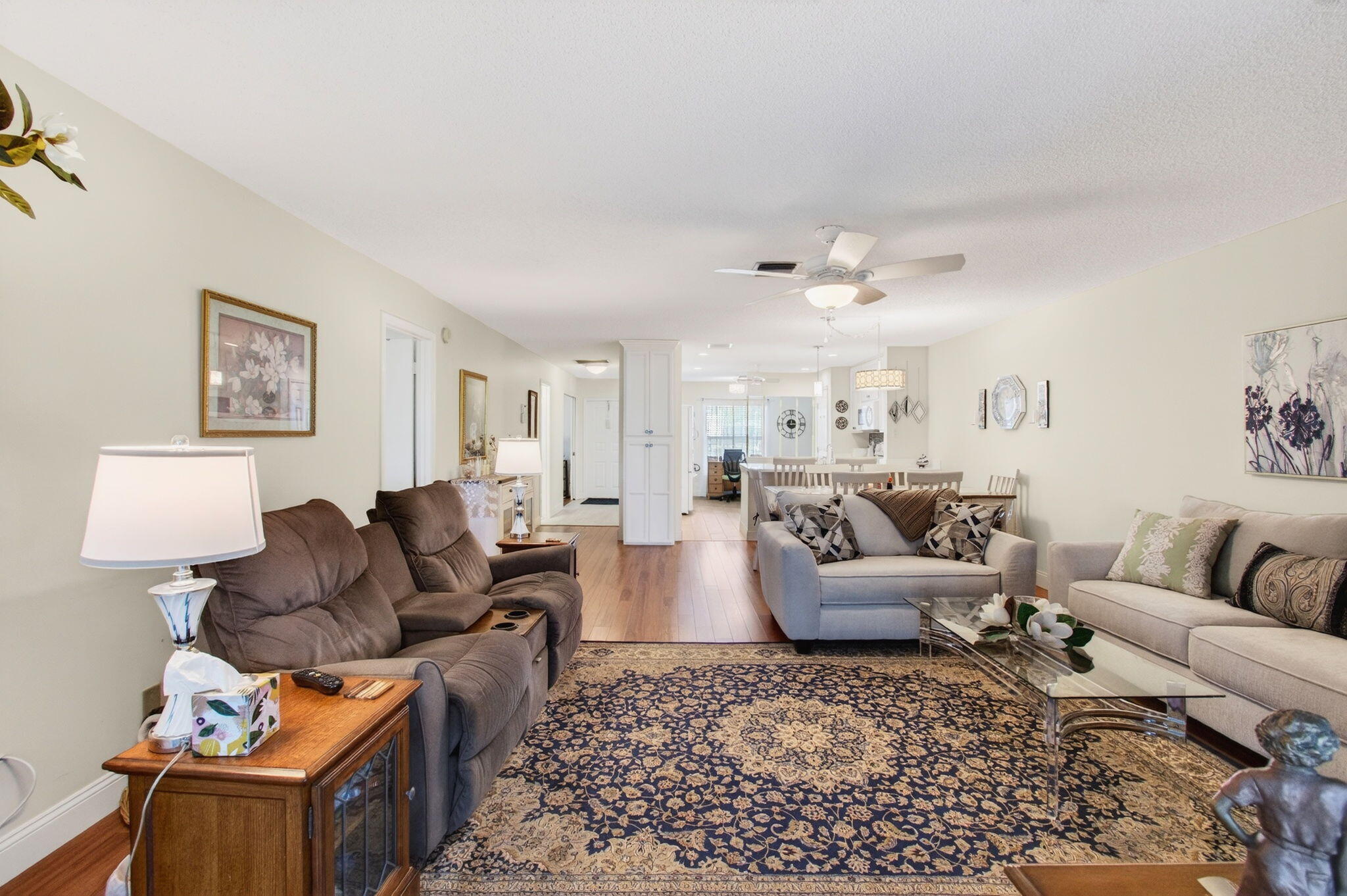 5452 Poppy Place, Unit D Delray Beach, FL 33484 - Photo 19 of 62 a living room with furniture ceiling fan and a rug