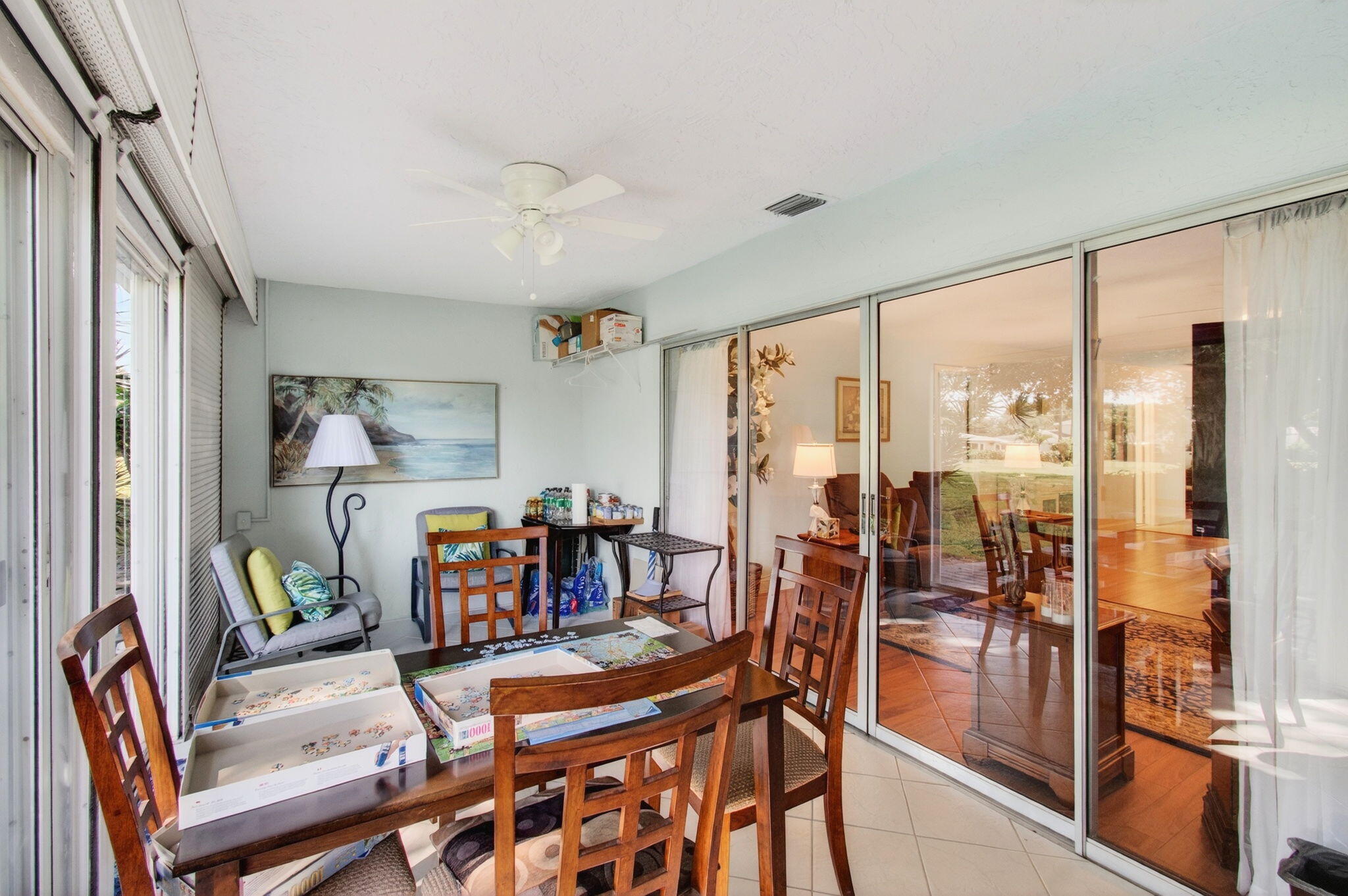 5452 Poppy Place, Unit D Delray Beach, FL 33484 - Photo 23 of 62 a dining room with furniture a chandelier and wooden floor